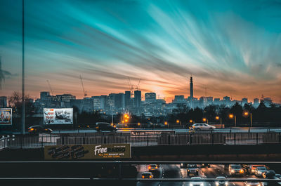 Illuminated cityscape against sky at night