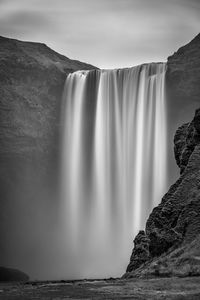 Scenic view of waterfall against rocks