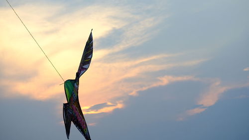 Low angle view of flags against sky during sunset