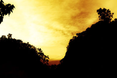 Silhouette trees against sky during sunset