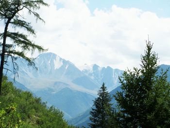 Scenic view of mountains against cloudy sky