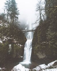 Scenic view of waterfall against sky