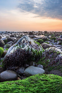 Scenic view of rocks against sky during sunset