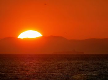 Scenic view of sea against orange sky