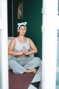 Young woman looking away while sitting outdoors