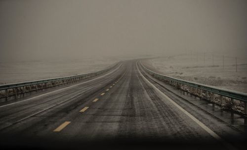 View of highway against sky during winter