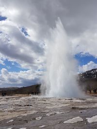 Scenic view of waterfall against sky