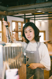 Portrait of a smiling barista girl.