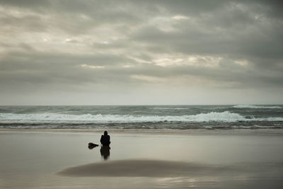 Man on beach against sky