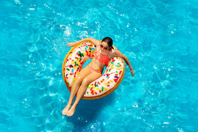 High angle view of man floating in swimming pool