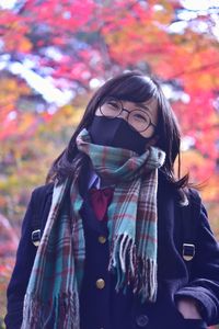 Portrait of young woman standing during autumn