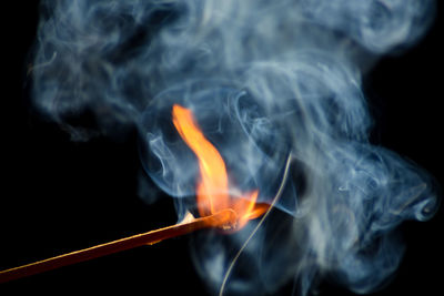 Close-up of burning fire against black background