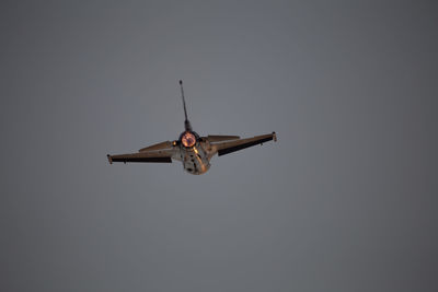 Low angle view of airplane flying against sky