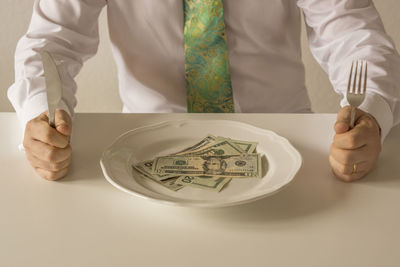 Midsection of man holding paper