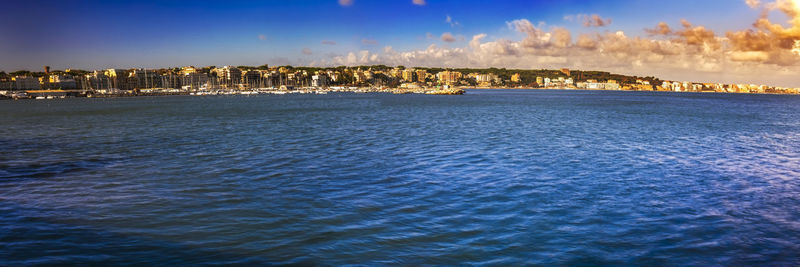 Scenic view of sea and buildings against sky