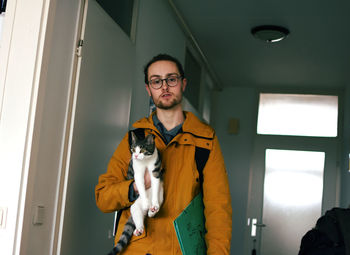 Portrait of man standing with dog