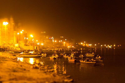 Boats in sea at night