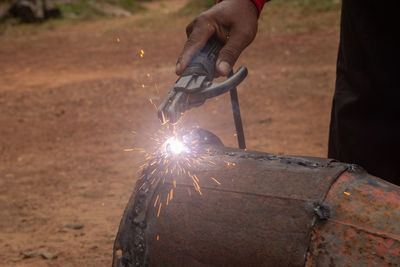 Midsection of man welding metal