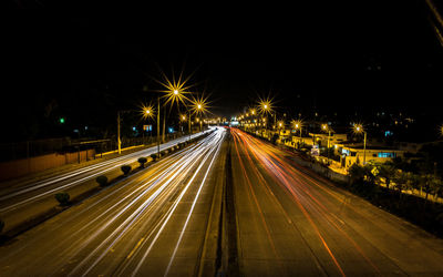 High angle view of light trails on road at night