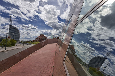 Panoramic view of city street and buildings against sky