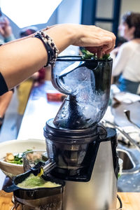 Close-up of hand pouring wine in glass