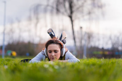 Portrait of woman lying on field