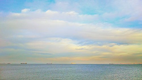 Scenic view of sea against cloudy sky