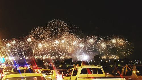 Low angle view of firework display against sky at night