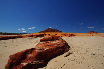 Rock formations in desert against blue sky