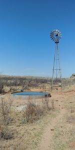 Scenic view of land against clear blue sky