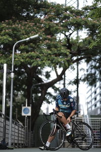 Man riding bicycle on street in city