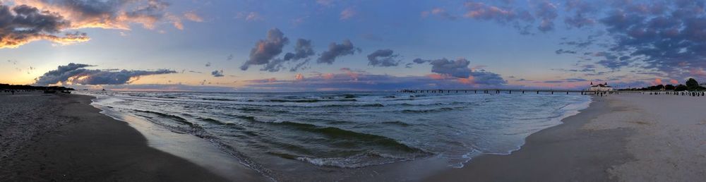 Panoramic view of beach against sky during sunset