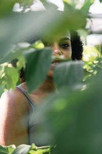 Portrait of young woman amidst plants