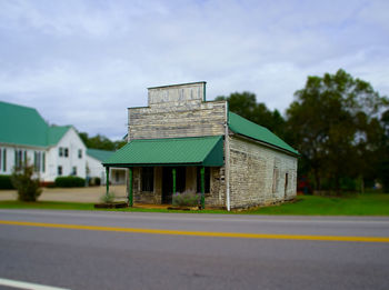 Surface level of road by building against sky