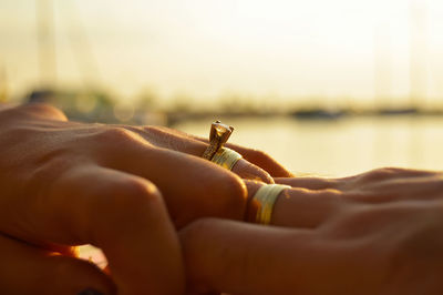 Cropped hands of couple wearing wedding rings