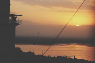 Scenic view of lake against orange sky