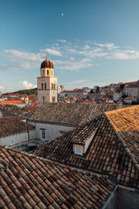 View of bell tower in town against sky