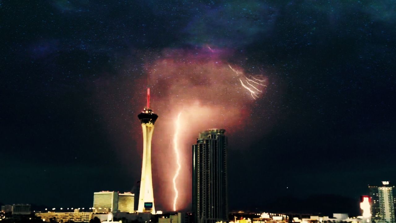 night, illuminated, building exterior, built structure, architecture, city, sky, low angle view, smoke - physical structure, tall - high, tower, skyscraper, smoke, travel destinations, capital cities, communication, outdoors, cityscape, danger