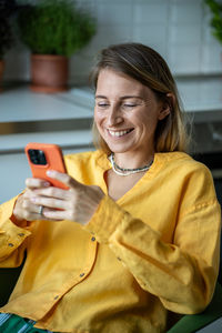 Overjoyed smiling positive woman with mobile phone, having video online call with friends, relatives