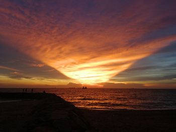 Scenic view of beach against sky during sunset