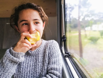 Portrait of young woman holding apple