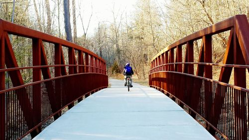 Woman walking on footbridge