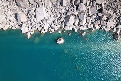 High angle view of rocks floating on sea