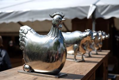 Animal figurines on wooden table for sale at market stall