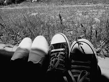 Low section of person relaxing on field