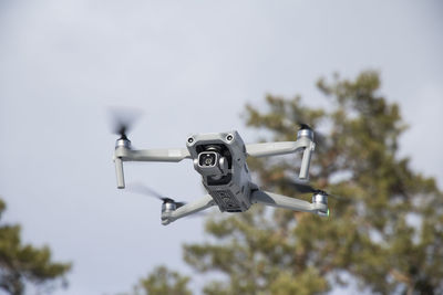 Low angle view of airplane flying against sky