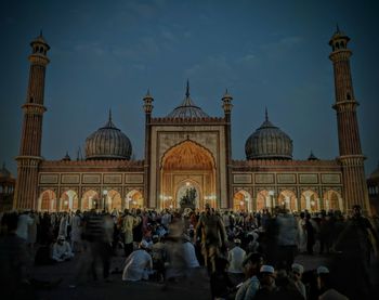 Group of people in front of building against sky