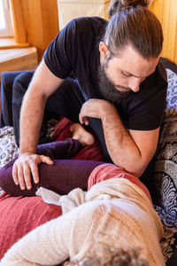 Side view of boy sleeping on bed at home