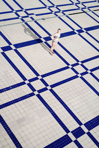 High angle view of woman standing on tiled floor