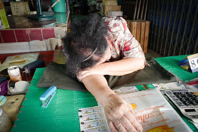 Full length of man reading book at table